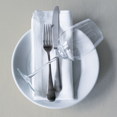 white plate with napkin, silverware and wine glass